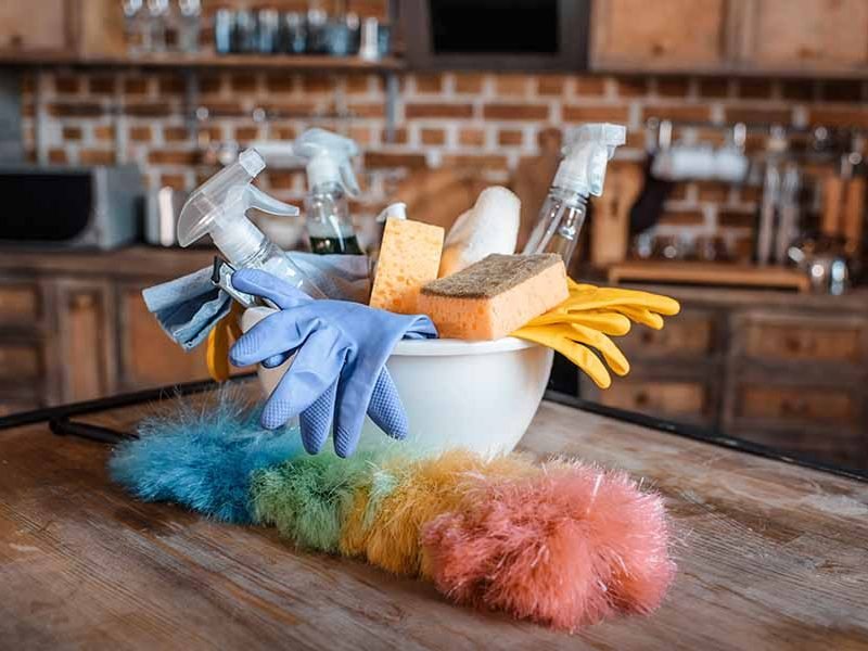 Close-up view of cleaning supplies on wooden table indoors
