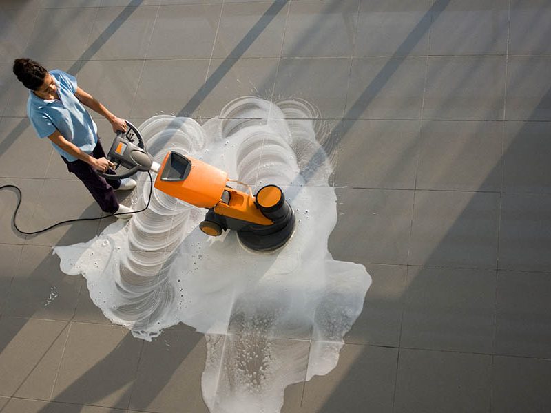 cleaning A worker is cleaning the floor with machine